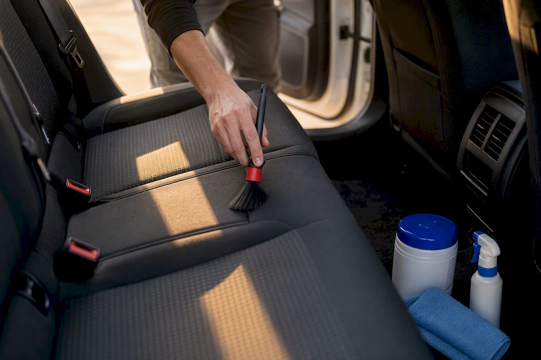 Hand cleaning rental car interior