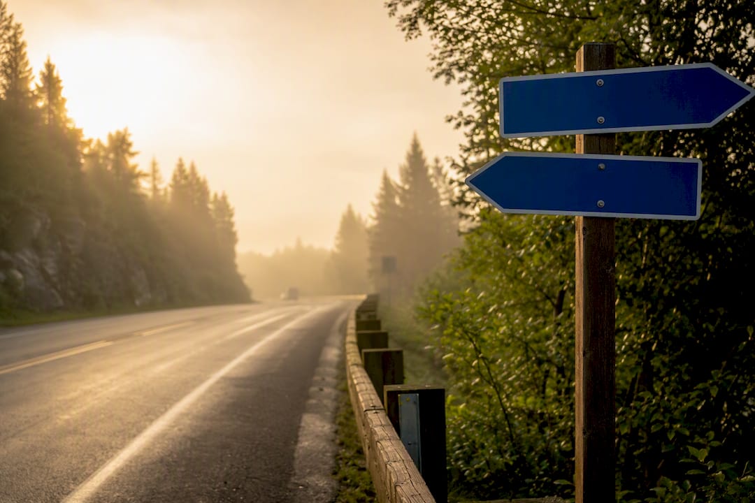 Highway with blank border crossing direction signs
