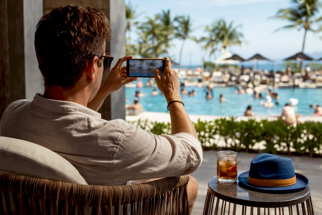 Traveler recording an ordinary resort pool scene