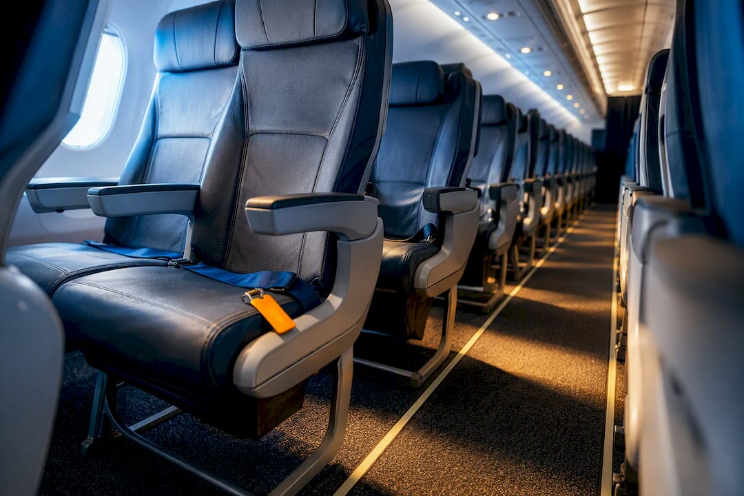 Airplane cabin seats viewed from aisle