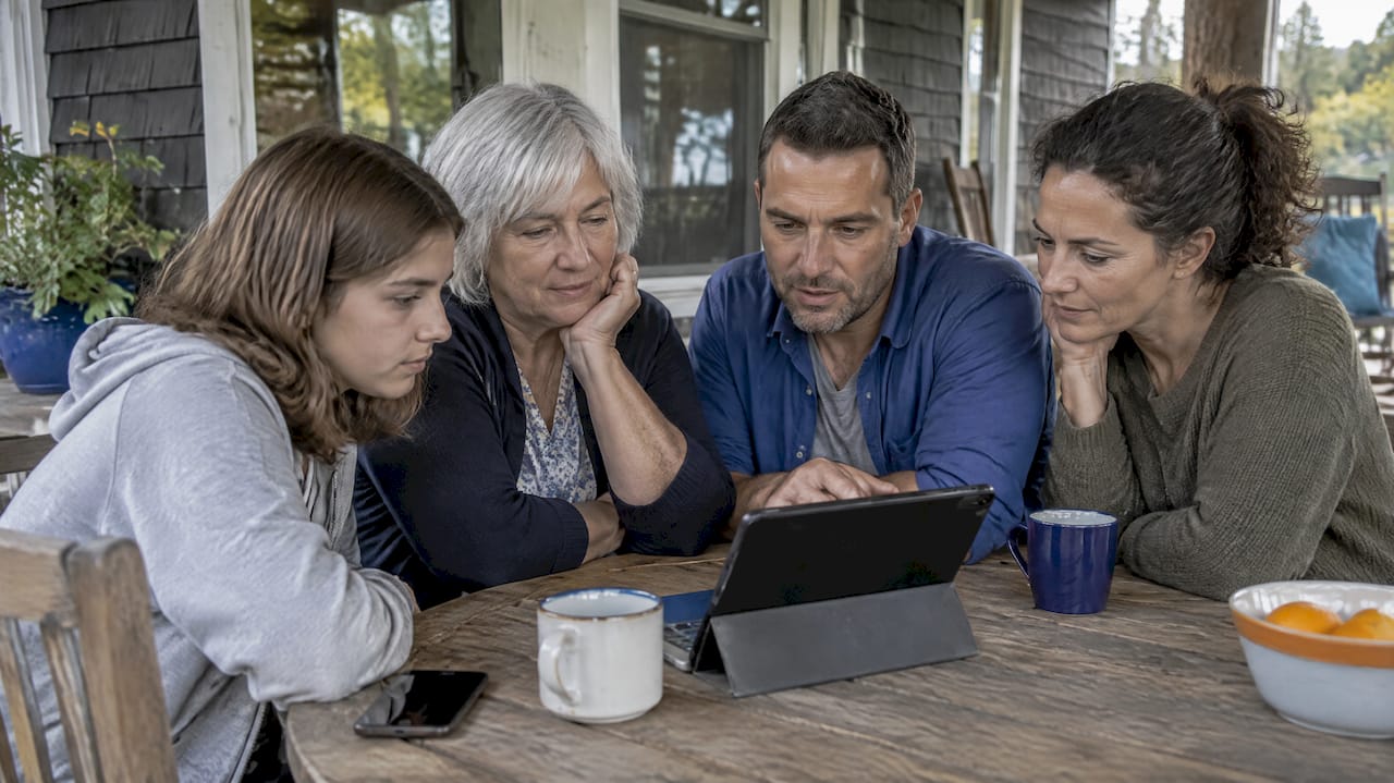 Relatives comparing trip dates on a tablet