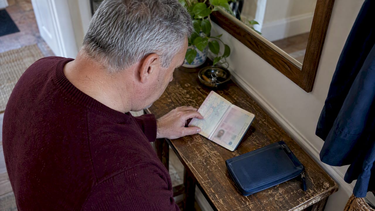 Traveler checking passport validity before a trip